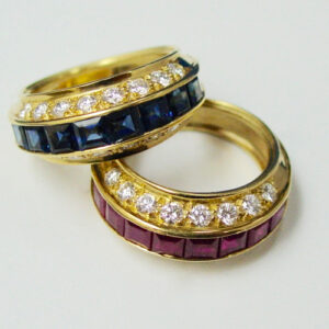 Matched Pair of 18 Karat Yellow Gold Ruby, Sapphire and Diamond Band Rings