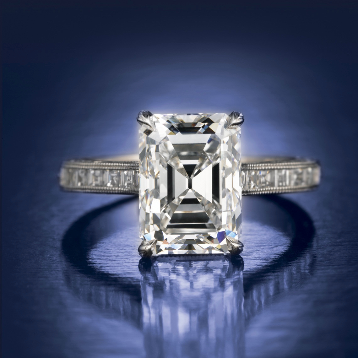A diamond ring with a large emerald cut diamond.