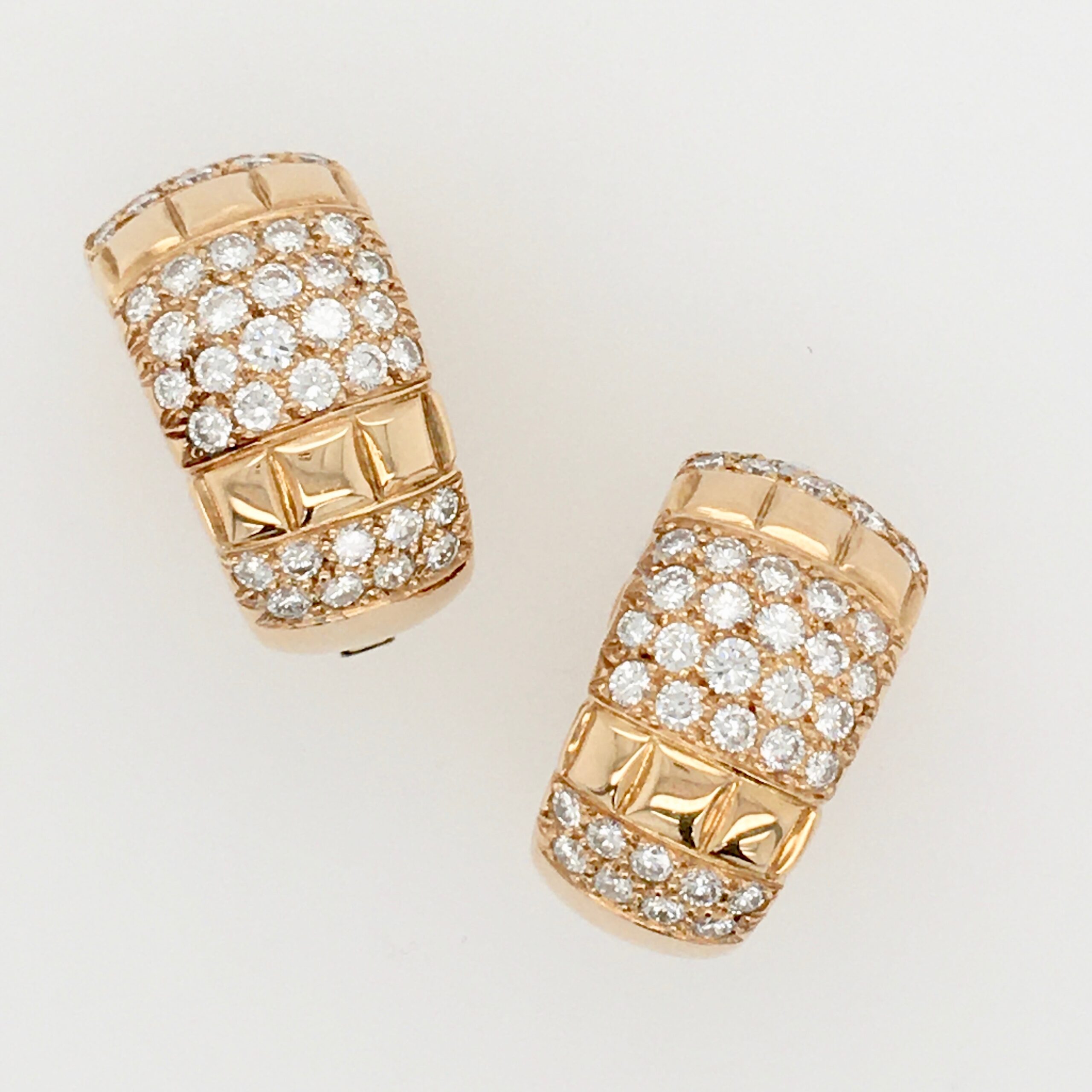 A pair of gold and diamond earrings.