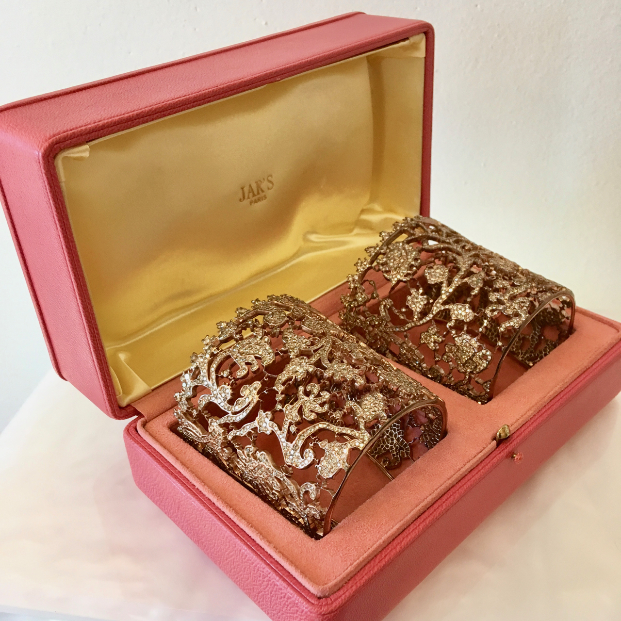 A pink box with two cakes in it