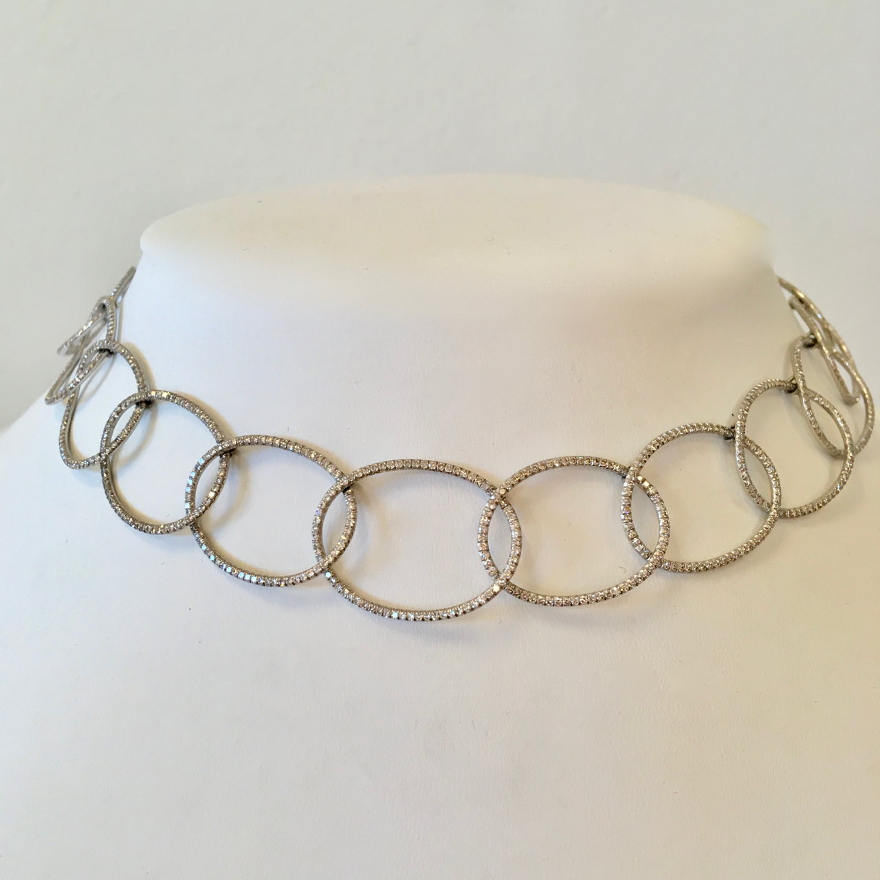 A close up of the necklace on a white collar