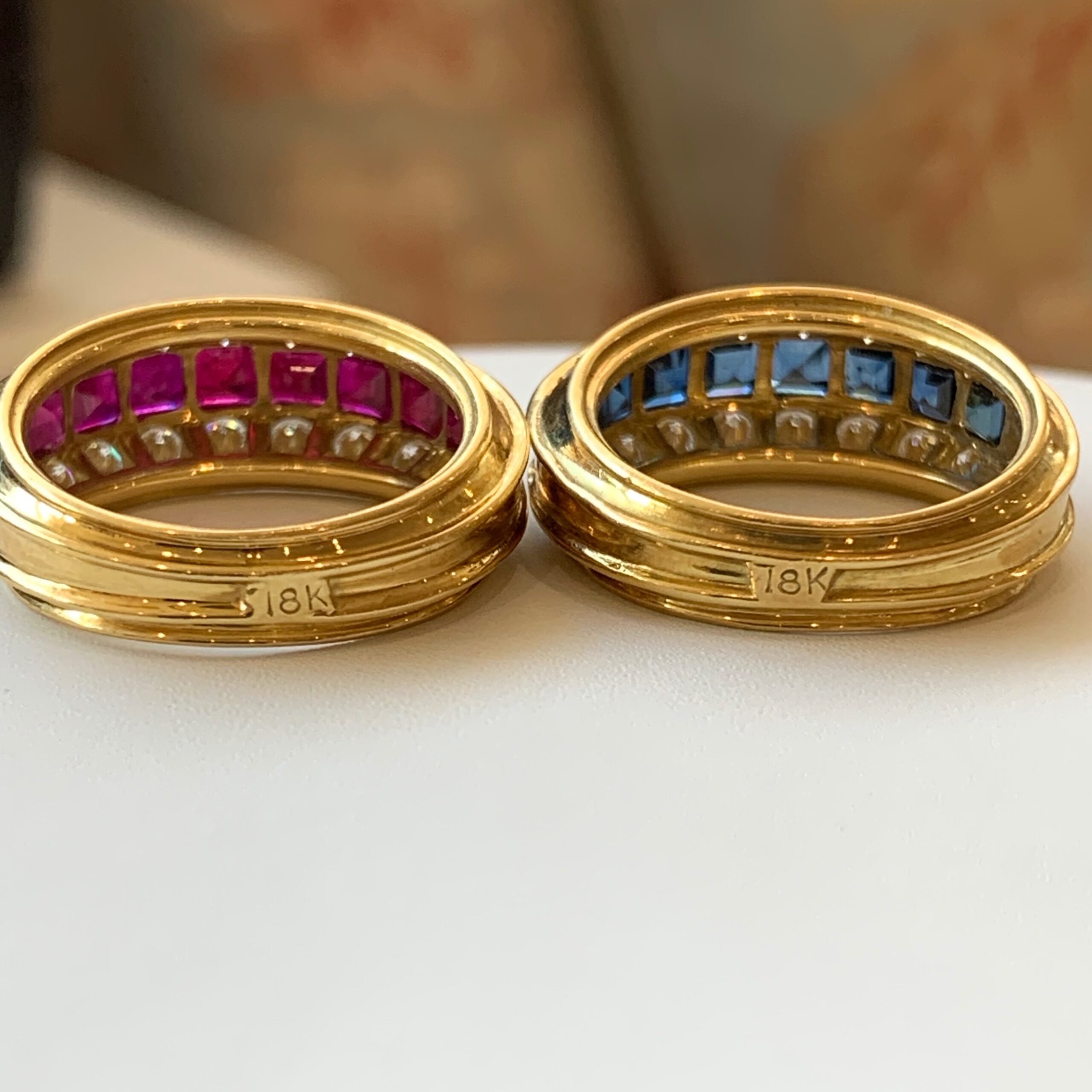 Two gold rings sitting on top of a table.