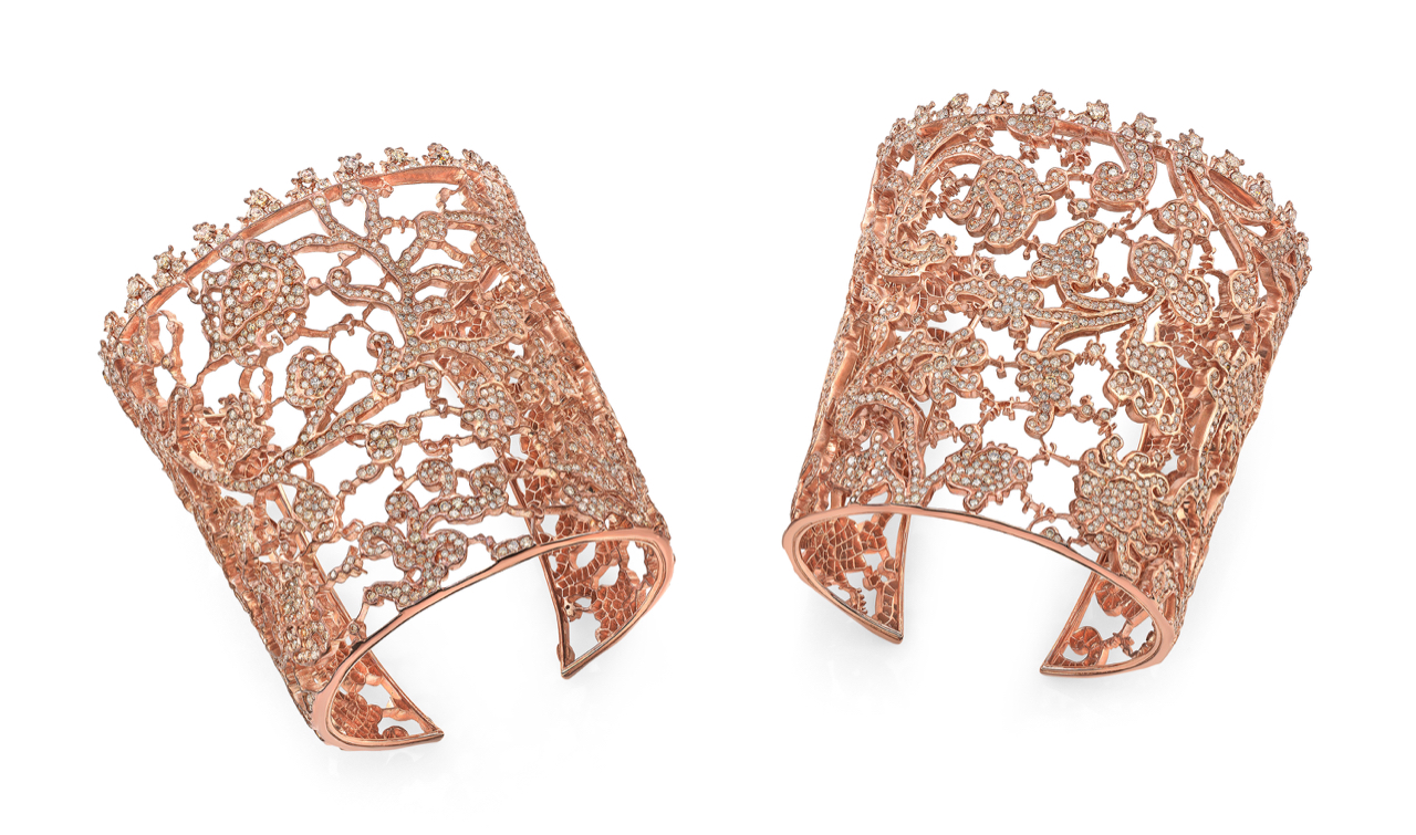 A pair of rose gold bracelets with floral design.