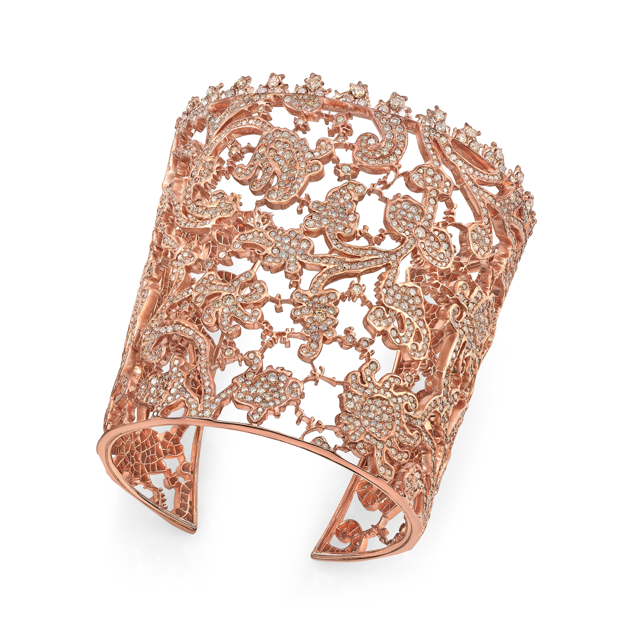 A rose gold cuff bracelet with intricate filigree design.