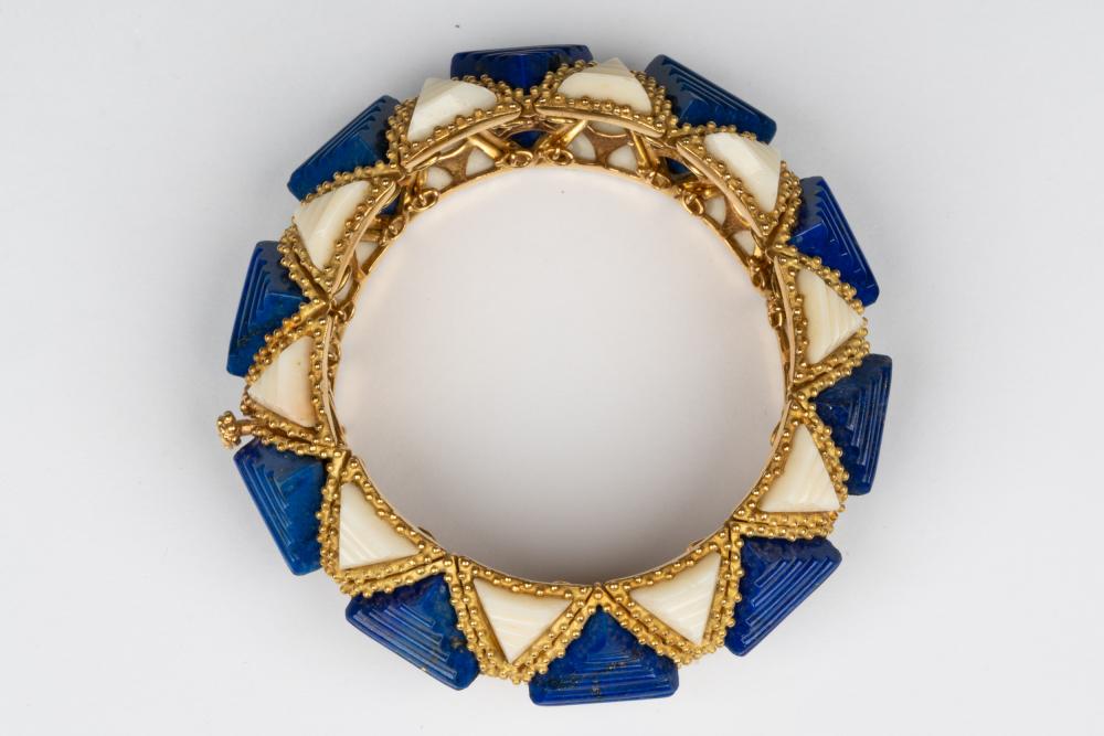 A gold and blue bracelet with white stones.