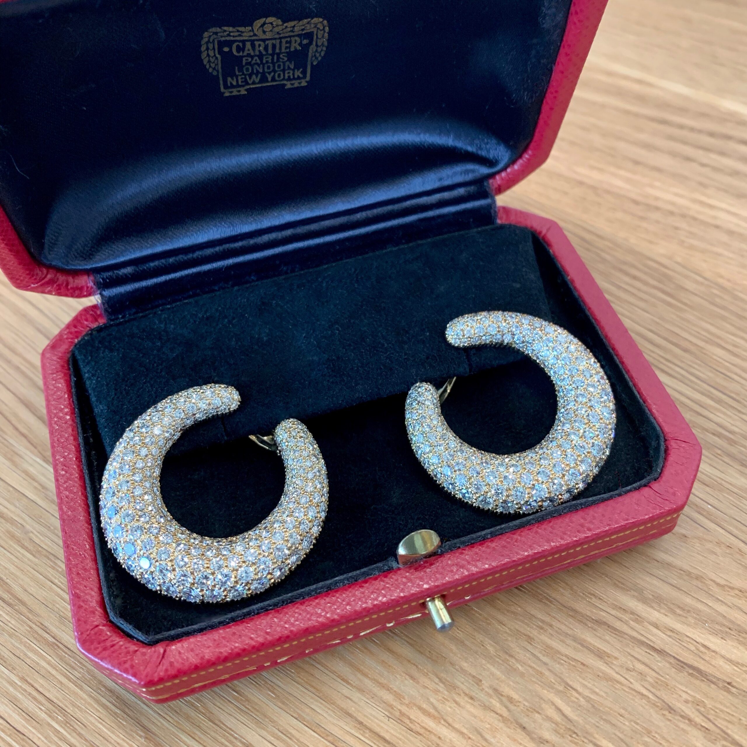 A pair of earrings in a red box.