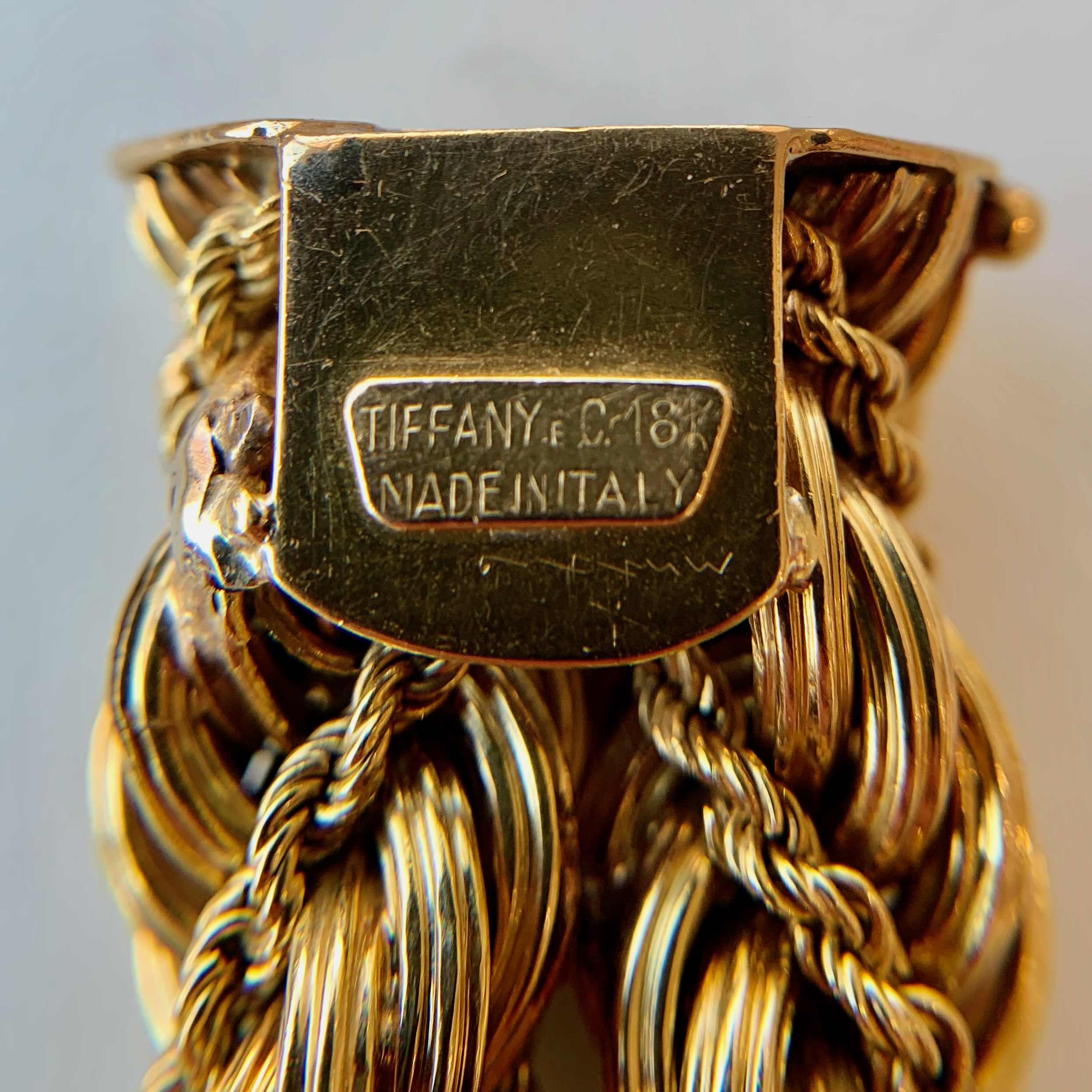A close up of the name plate on a gold bracelet