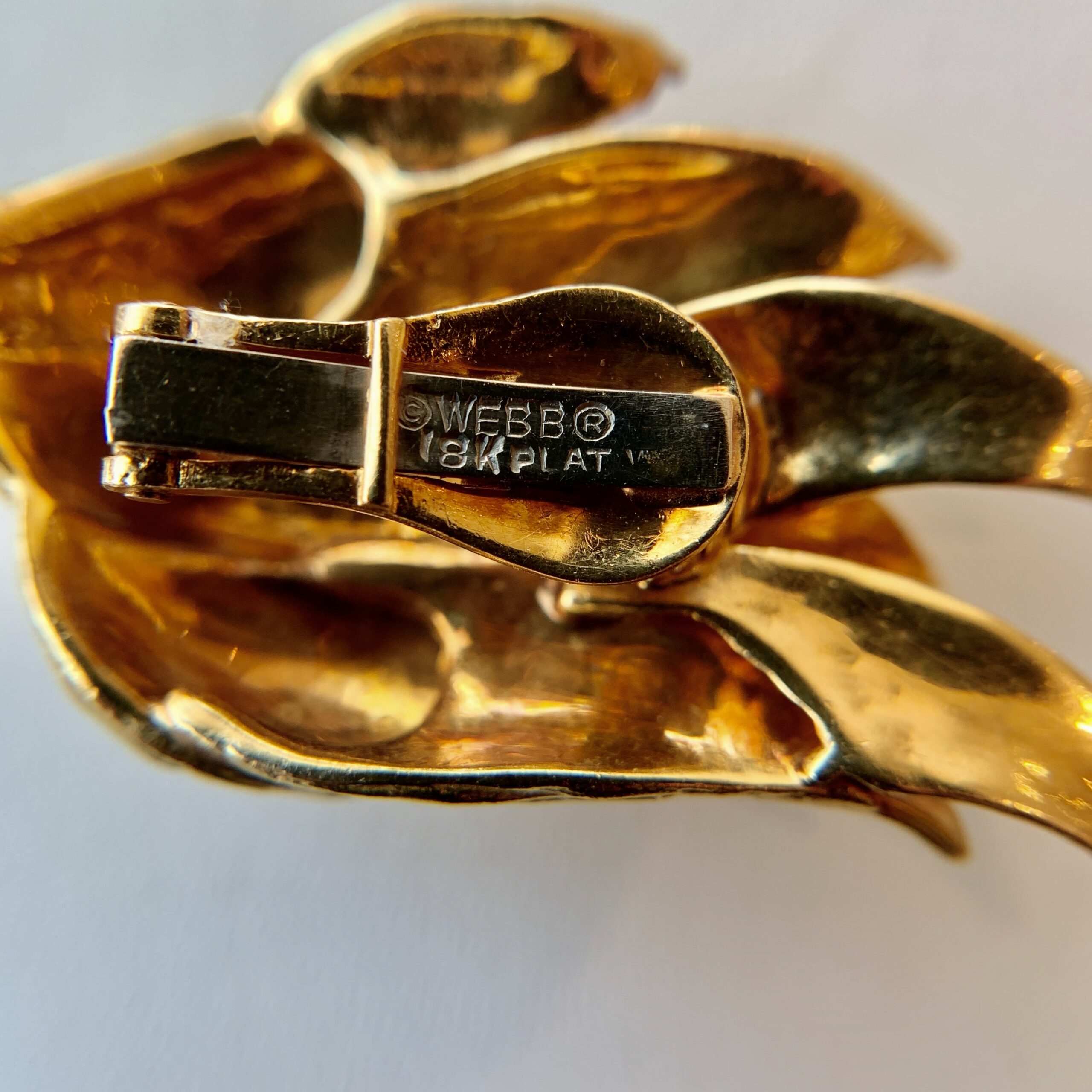 A close up of the back of a gold bracelet
