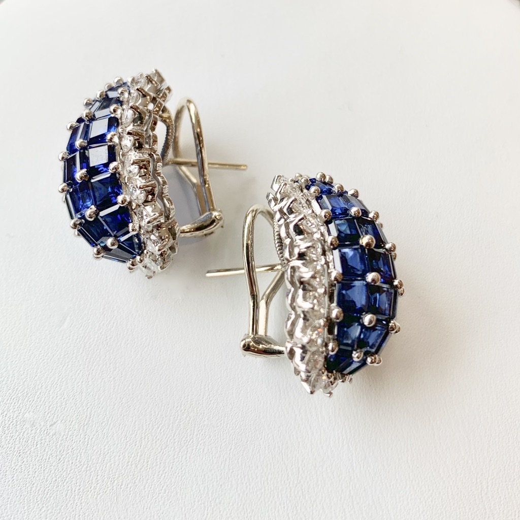 A pair of blue and white diamond earrings.