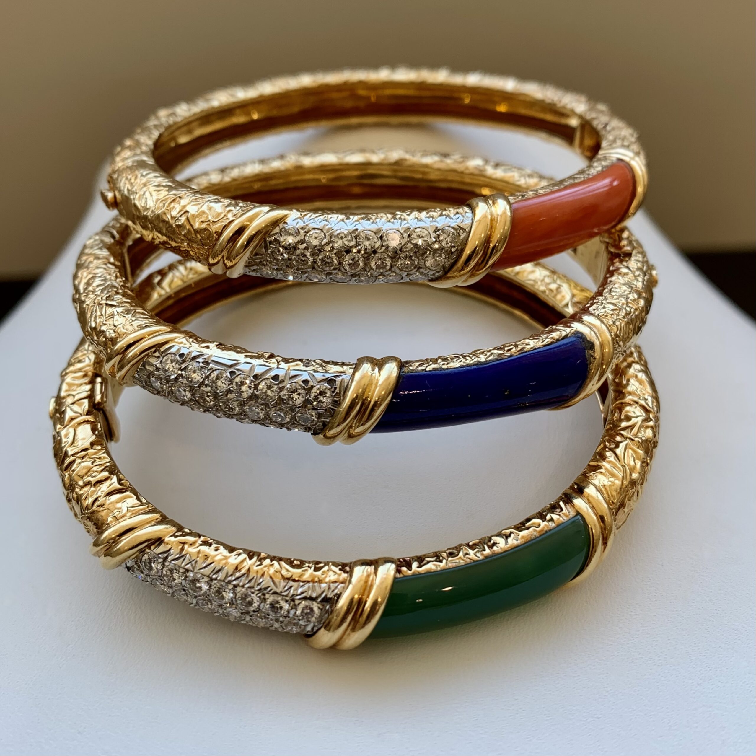 Three bracelets are shown on a white surface.