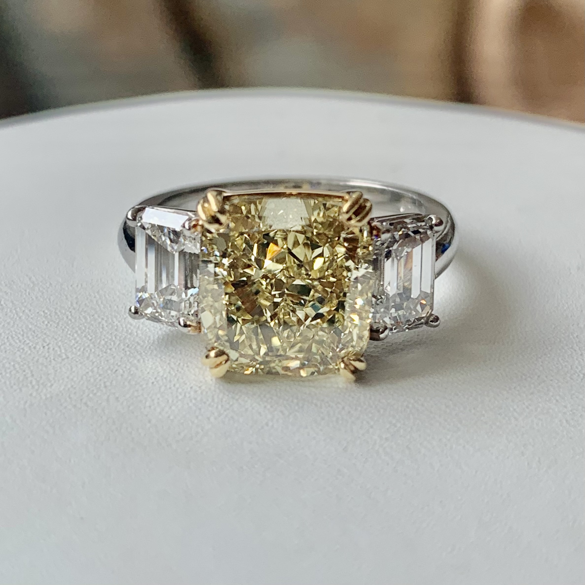 A yellow diamond is sitting on top of a white table.