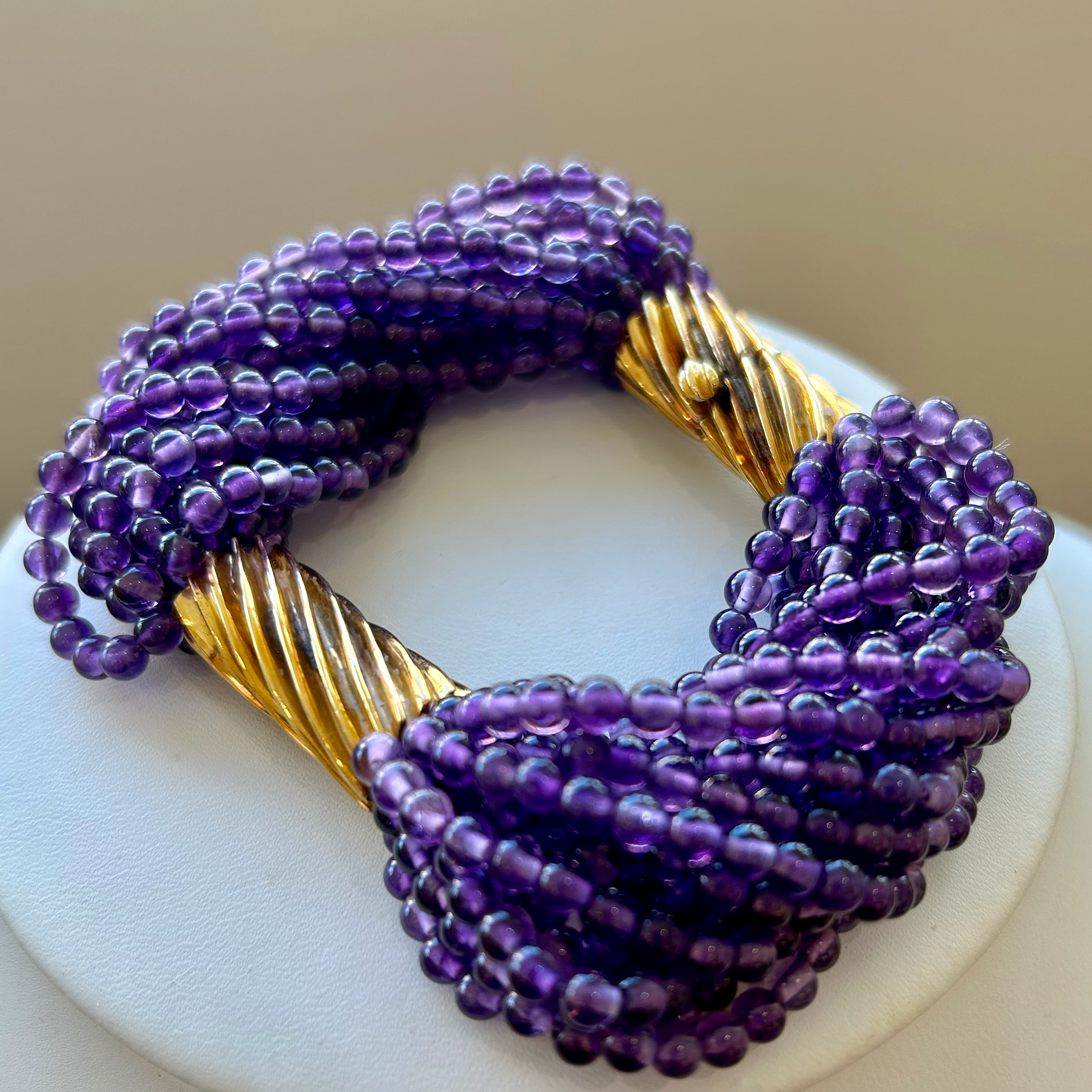 A close up of a necklace on a white plate