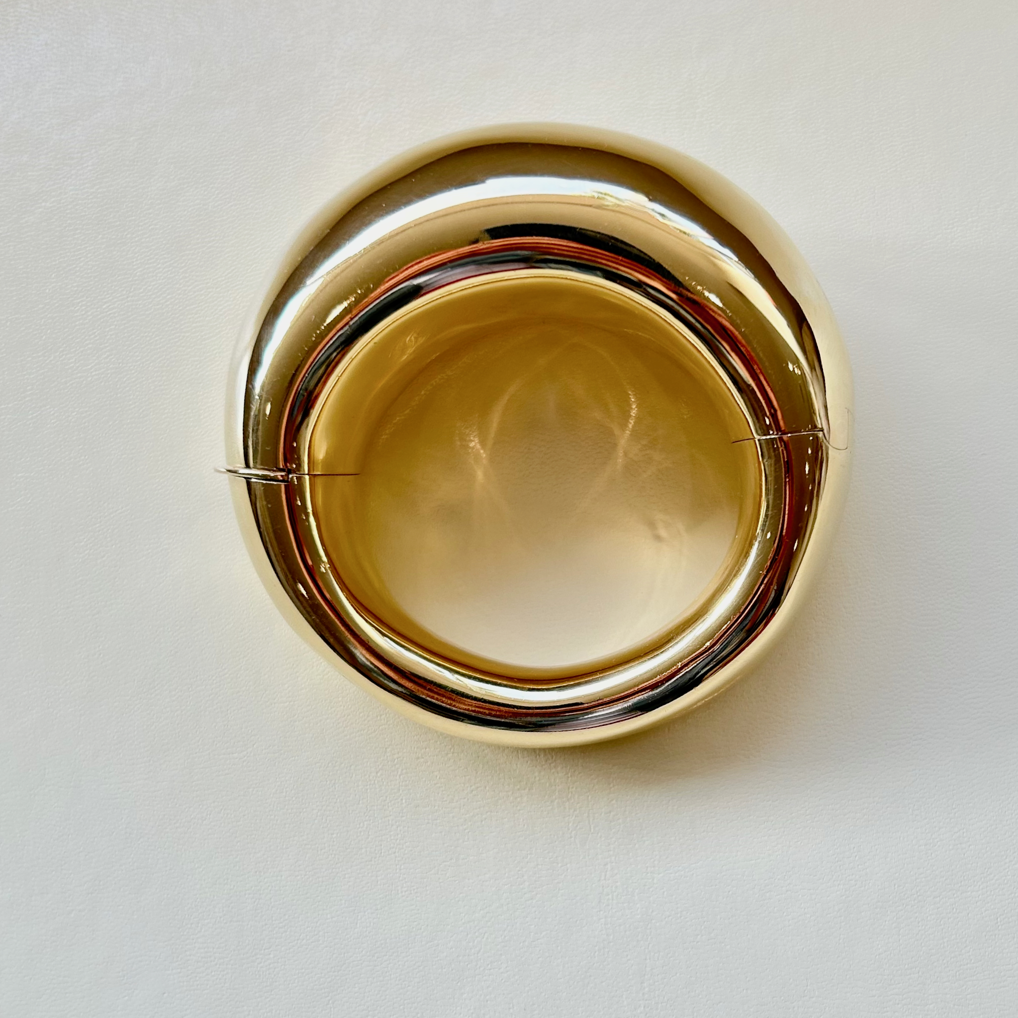 A close up of two gold bangles on top of each other